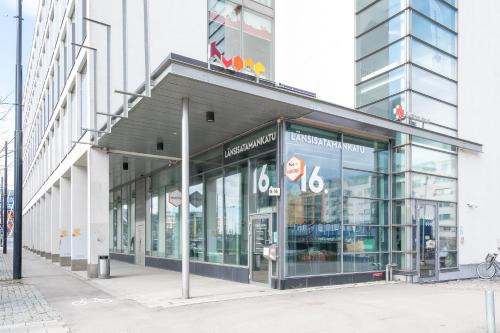 a store front of a building with glass windows at Hiisi Hotel Helsinki Jätkäsaari in Helsinki