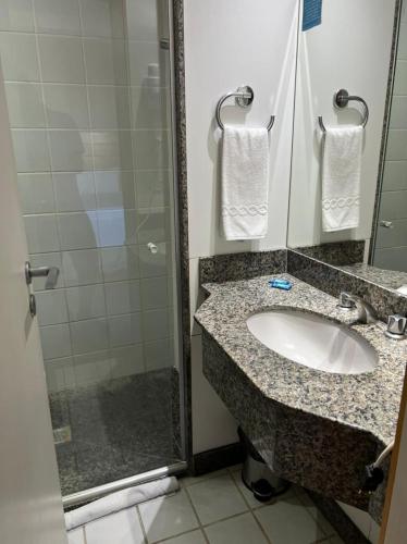 a bathroom with a sink and a shower at San Diego Apart- Hotel in Belo Horizonte