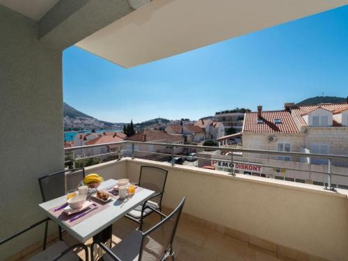 a balcony with a table and chairs and a view at Apartment Corto Maltese in Dubrovnik