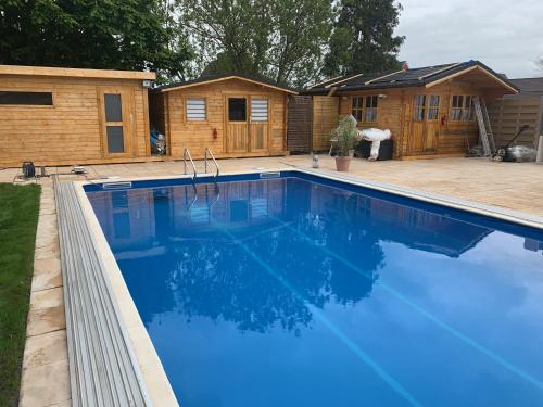 a swimming pool in front of a house at Familie Decker-Behrends in Upleward