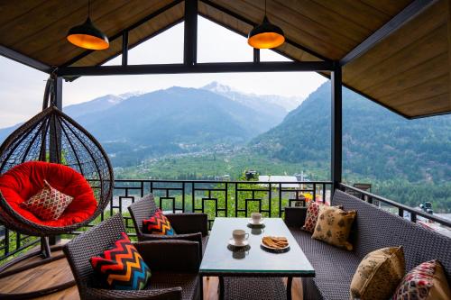 a room with a balcony with a view of mountains at Zostel Manali, Vashisht in Vashisht