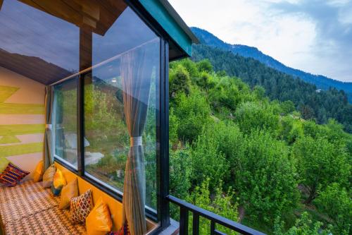 a balcony with a view of the mountains at Zostel Manali, Vashisht in Vashisht