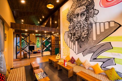 a room with a large mural on the wall at Zostel Manali, Vashisht in Vashisht