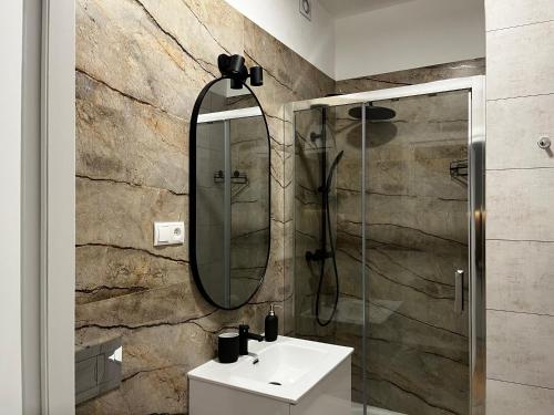 a bathroom with a sink and a mirror at Apartamenty Rynek 5 in Lublin