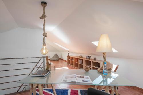a dining room with a table and a lamp at Casa do Castelo by An Island Apart in Funchal