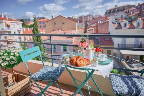 a table with a plate of food on a balcony at Grand Studio Cannes Centre in Cannes