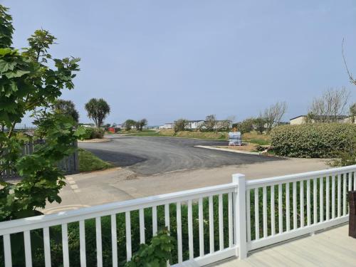 a view of a road from a white fence at Mawgan Pads Perranporth in Cubert