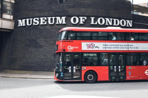 a red double decker bus parked in front of a building at citizenM London Victoria Station in London