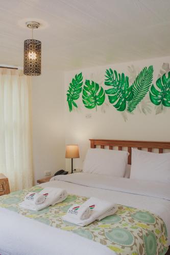 a bedroom with a bed with two towels on it at Rupa Rupa High Jungle Eco B&B in Machu Picchu