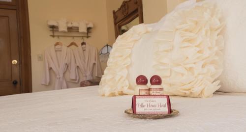 
a wedding cake on a bed with pillows at Teller House in Silverton
