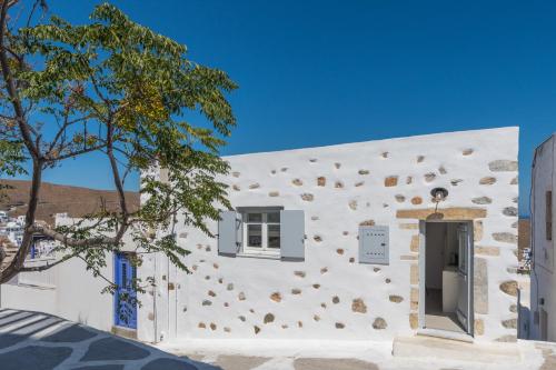 a white building with a window and a door at Karai, The House Project in Astypalaia Town