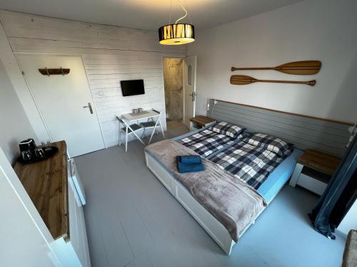a bedroom with a bed and a table in it at Sun & Fun in Władysławowo
