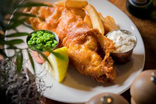 a plate of food with fish and chips and dip at Beaulieu Hotel in Lyndhurst