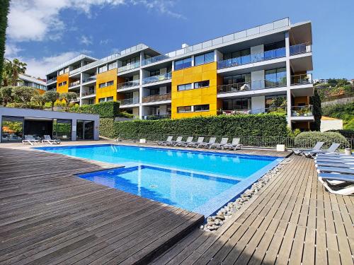 a swimming pool in front of a apartment building at The Bay View - by LovelyStay in Funchal