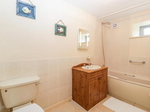 a bathroom with a toilet and a sink and a tub at Carthouse in Weston-super-Mare