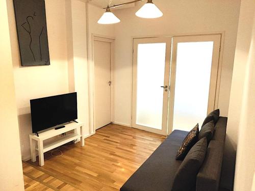 a living room with a couch and a flat screen tv at Reipas in Kotka