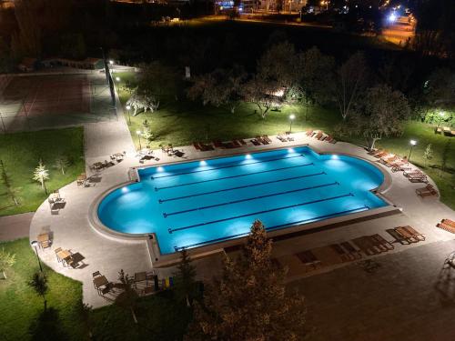 an overhead view of a swimming pool at night at CONNECT THERMAL HOTEL in Ankara