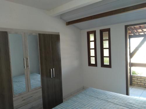 a bedroom with a bed and a mirror at CASA AMARELA in Salvador
