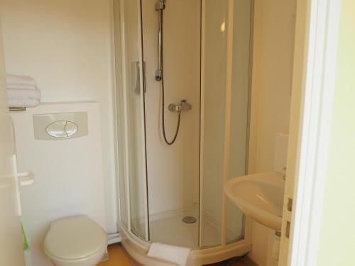 a bathroom with a shower and a toilet and a sink at Hôtel Le Vivier WISSANT - Rivière in Wissant
