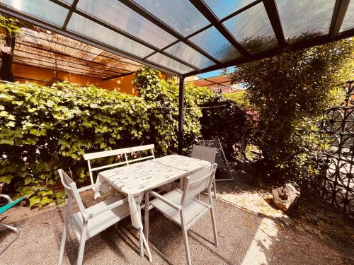 a table and chairs sitting under a patio umbrella at Hotel Baia di Levanto in Levanto