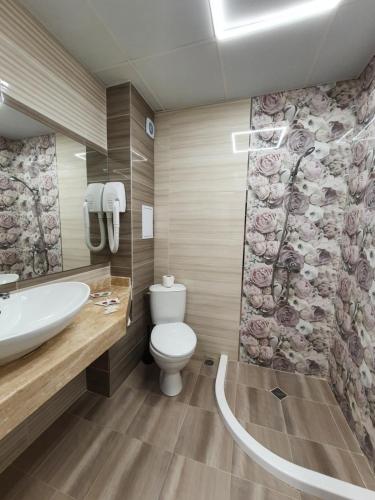 a bathroom with a toilet and a sink at Palma in Burgas City