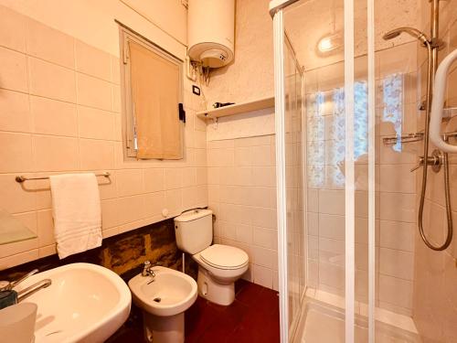 a bathroom with a toilet and a sink and a shower at Hotel Baia di Levanto in Levanto