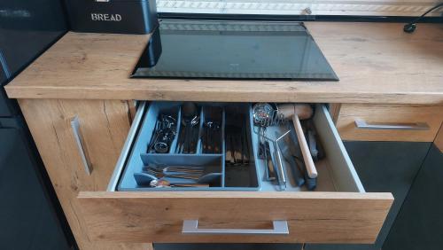 a drawer in a kitchen with utensils in it at Domek nad Czerwienią in Przesieka
