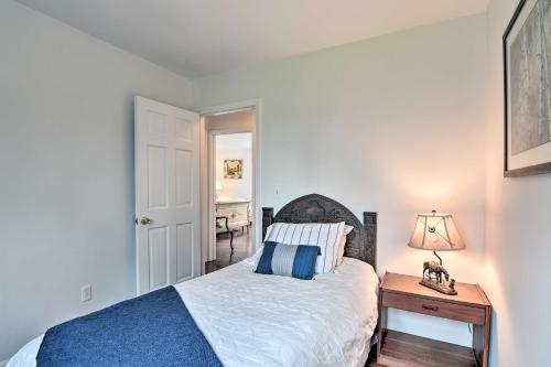 a bedroom with a bed and a table with a lamp at Lovely Highland Home with Pool and Hot Tub! in Highland