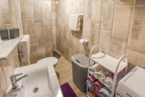 a bathroom with a white sink and a toilet at House Roko and Karla in Kali