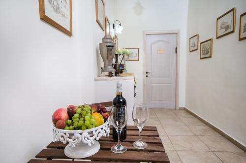 a table with a bowl of fruit and wine glasses at The Spirit Of Tzfat Villa in Safed