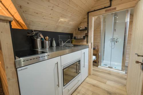 a kitchen with a sink and a stove at Punch Tree Cabins Couples Outdoor Bath in Carluke