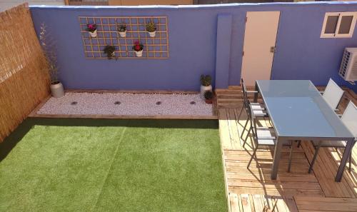 un patio con mesa, sillas y una pared azul en Casa Planta Baja.VTLR1431, en Rincón de Soto