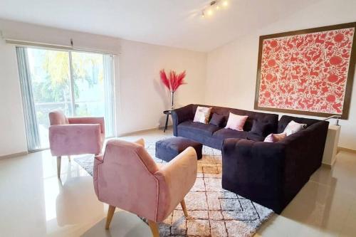 a living room with a couch and two chairs at VILLA CHLOE. Modern 4 rooms house with pool in Cancún