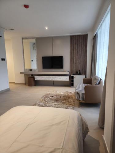 a large living room with a television and a couch at Imperial Suites Hotel in Manama