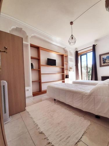 a bedroom with a large bed and a tv at Albergue Villa San Clemente in Tui
