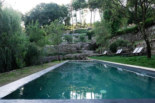 a large pool of water surrounded by trees at Casa Agricola da Levada Eco Village in Vila Real