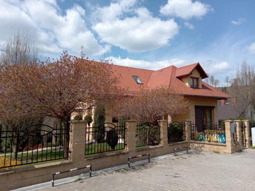 a house with a fence in front of it at Pokoje Gościnne Monti in Kudowa-Zdrój