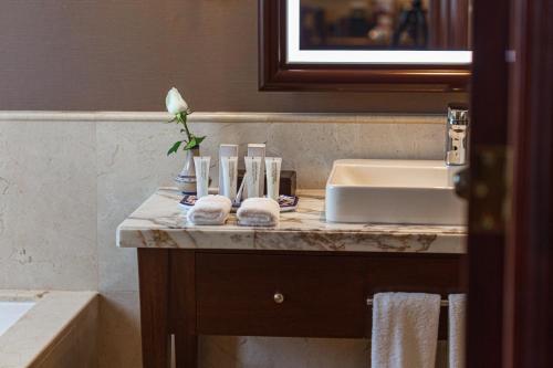 a bathroom with a sink and a counter with towels at Country Club Lima Hotel – The Leading Hotels of the World in Lima