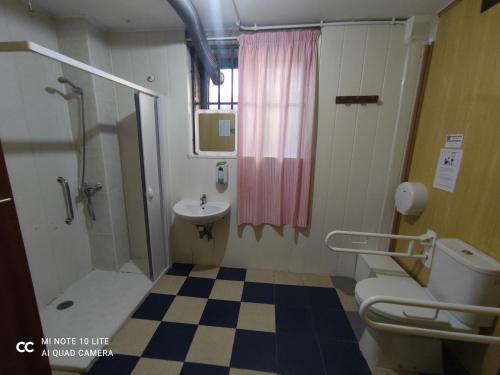 a bathroom with a sink and a toilet and a shower at Albergue Villa San Clemente in Tui