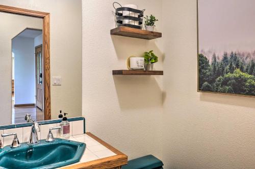 a bathroom with a green sink and a mirror at 10 Acres with Stunning Views Apple Hill Home! in Camino