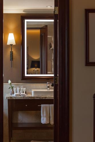 a bathroom with a sink and a large mirror at Country Club Lima Hotel – The Leading Hotels of the World in Lima