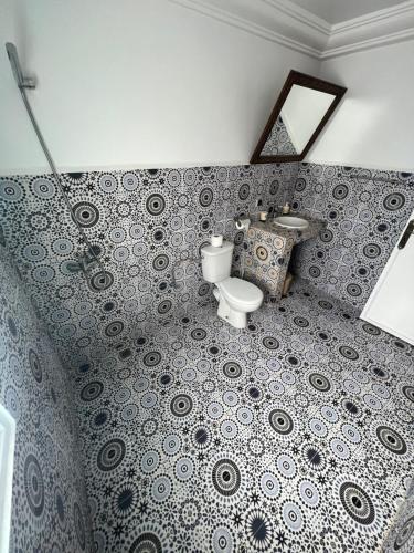 a bathroom with a toilet and a sink at Dar Surf in Taghazout
