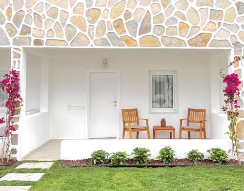 a patio with two chairs and a table at Lavinya Otel in Golturkbuku