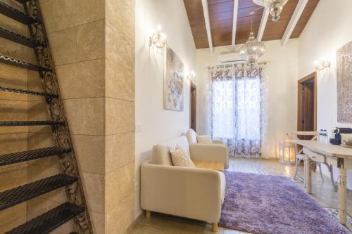 a living room with a couch and a dining room at Casa Mistela in Jalón