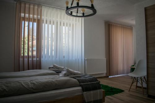 a bedroom with two beds and a large window at Casa al Tagas in Kruševo