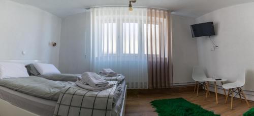 a bedroom with a bed and a large window at Casa al Tagas in Kruševo