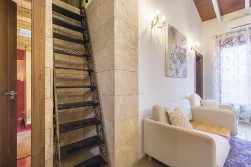 a living room with a white couch and a staircase at Casa Mistela in Jalón