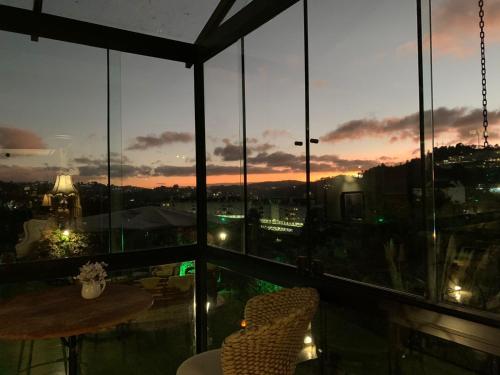a balcony with a view of a city at night at Casablanca Hotel Boutique in Campos do Jordão