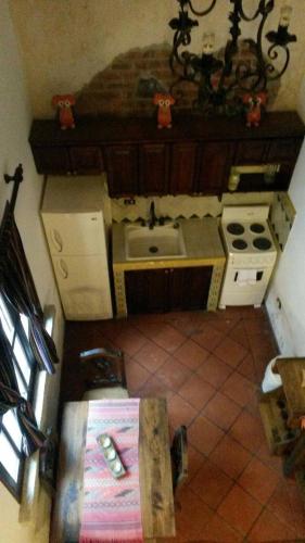 a small kitchen with a stove and a sink at Casita Acogedora in Antigua Guatemala