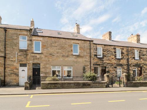a large brick building on the side of a street at The Old Sweet Shop in Alnwick